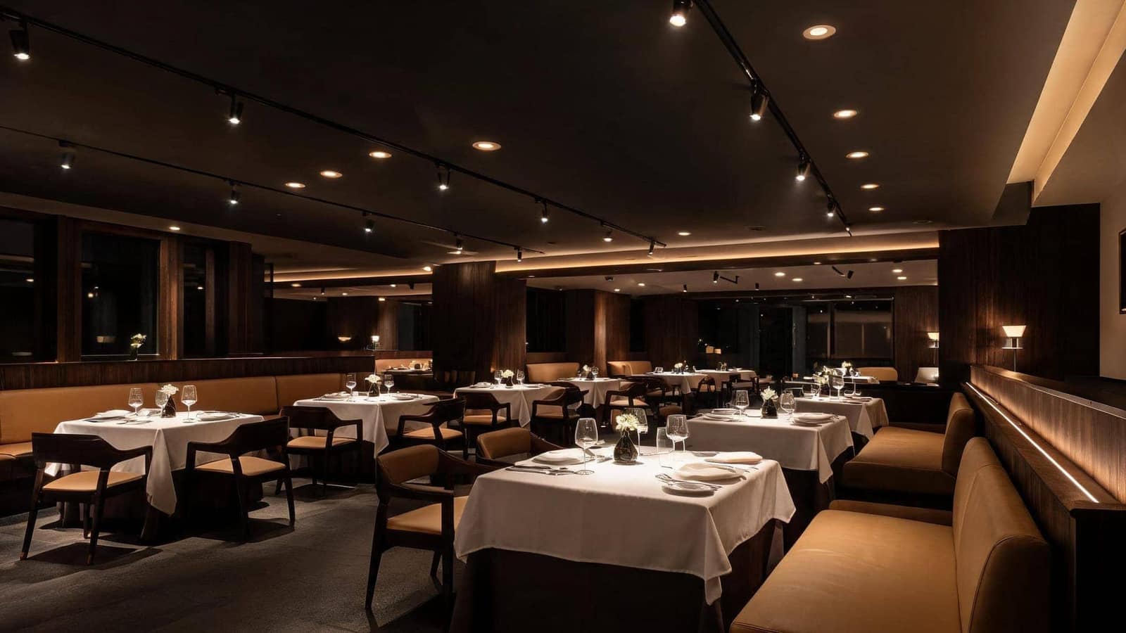 Fine dining restaurant with warm ambient lighting and accent spotlights